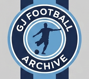 Manchester City player in blue dribbling a soccer ball during a match